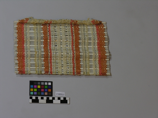 Hearst Museum object titled Blinds sample, accession number 2-68317, described as Sample for blinds or room partitions; wrap- white, orange, silver cotton, synthetic and mylar yarns; weft - white painted reed and bamboo slating and white chenille chenille, rayon, mylar, maylar braid, bamboo, reed, plain weave. H: 26 cm, W: 34 cm. Industrial textile.