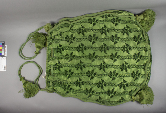 Hearst Museum object titled Bag, accession number 7-3224, described as Bag; green silk; satin-weave ground; cut pile floral designs in bands; raw silk lining; heavy tassels; braid drawstrings. 21 x 21 1/2 inches without tasels.