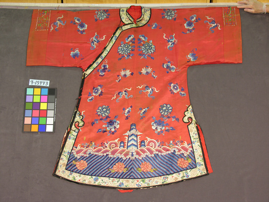 Hearst Museum object titled Robe, accession number 9-15443, described as Robe; silk, gilt paper wrapped yarns; brass buttons; satin, embroidered; red ground, multicolored designs, red lining; 49 inches long, 25 inches neck to cuff edge; flowers, bats, human figures, other motives.