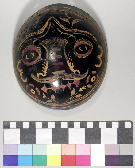 Hearst Museum object titled Jicara mask, accession number 3-15405, described as Jicara mask-black with incised figures which have been colored with fuchsia or turquoise analine dye.