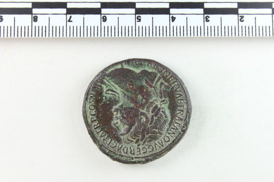 Hearst Museum object 5 of 14 titled Coin: æ sestertius, accession number 8-4007, described as Coin; AE; Sestertius; Roman. Trajan, 104-111 AD. Rome, Italy. Obverse: IMP CAES NERVAE TRAIANO AVG GERM DAC PM TRP COS V PP, Bust laureate and draped. Reverse: [SPQR OPTIMO] PRINCIPI, [ARAB] ADQ [VIS] in ex (as on denarii); S C in field. CF Coin 4008.