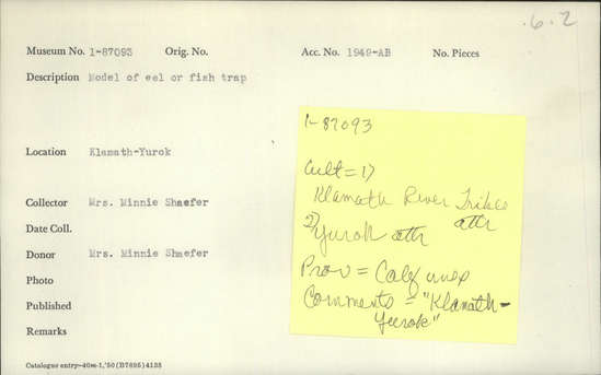 Documentation associated with Hearst Museum object titled Trap model, accession number 1-87093, described as Eel or fish trap.  Tag "Yurok" scratched out.  Second tag "Klamath River Tribes att.". Per Ralph Shanks:  Twined openwork basket trap model, either for eel or fish, with handle. Bundled starting knot.  The warp material is hazel.  The weft is conifer root.  The weft overlay is a beargrass, red-dyed woodwardia, and maidenhair fern. The handle is made of braided beargrass and red-dyed woodwardia.  The handle is attached to the base of the basket with a beargrass and maidenhair fern wrapped rod.  There are four bands of close work twining, all plain twined.  The rim is twisted over to the interior and trimmed.  The basket has an up to the right slant of weft twist, with a rightward work direction.  The design overlay is single sided on the exterior.  The basket is from Northwestern California.