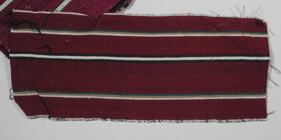 Hearst Museum object titled Textile fragment, accession number 5-11288, described as textile sample (section of narrow band weaving): maroon ground, white selvages, two narrow stripes of green, tan, and white, one white flanked each side by black.