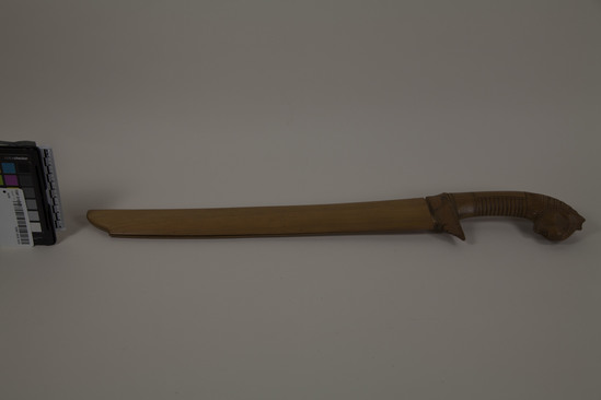 Hearst Museum object 1 of 5 titled Knife, accession number TEMP 2018.1415, described as Javanese parang knife, carved sheath and handle with animal head. overall 22" length.