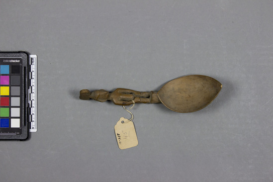 Hearst Museum object titled Spoon, accession number 10-697, described as Wooden spoon; carved handle of standing female figure with headdress; slightly polished; length: 7½ inches.