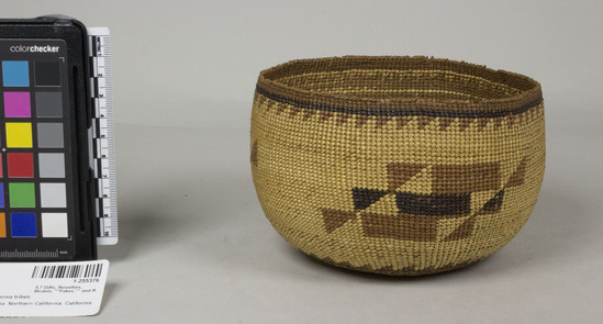 Hearst Museum object 2 of 2 titled Bowl basket, accession number 1-255376, described as Bowl-shaped basket. Twining with overlay designs. Band of triangles below rim, rectangles and triangles on body. Ink - stained interior. Minor rim damage. Tag "Klamath R. Tribes Att.". Per Ralph Shanks:  Twined basket bowl. The basket has a crossed warp starting knot.  The warp material is hazel.  The background weft is conifer root.  The weft overlay is beargrass, maidenhair fern, and red-dyed woodwardia.  At the starting knot there is three strand twining that extends for .5 inch, changing to plain twining for 1 inch, and then 1 weft row of three strand twining, followed by  plain twining which continues up to the rim, where the last weft row is three strand twining. Starting at the base the three rod twining has no overlay, after which there is a band of alternating beargrass and woodwardia.   At the edge of the base and at the rim there are two horizontal bands of woodwardia triangles with a line of maidenhair fern.  The main design is comprised of three elements formed by diagonal sets of triangles and rectangles. The rim has four weft rows of conifer root with no overlay. The basket has an up to the right slant of weft twist.  The basket has a rightward work direction with an exterior workface.  The overlay is on the outside, with some beargrass overlay carried into the inside.  The rim is trimmed.  The basket is from Northwestern California.