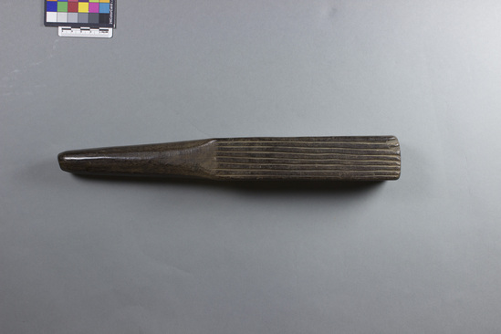 Hearst Museum object titled Tapa beater, accession number 11-40681, described as Quadrangular blade has 2 sides with deep longitudinal grooves, one pitted side, one side with shallow longitudinal grooves with some incised dots; rounded handle. Made of carved hardwood.