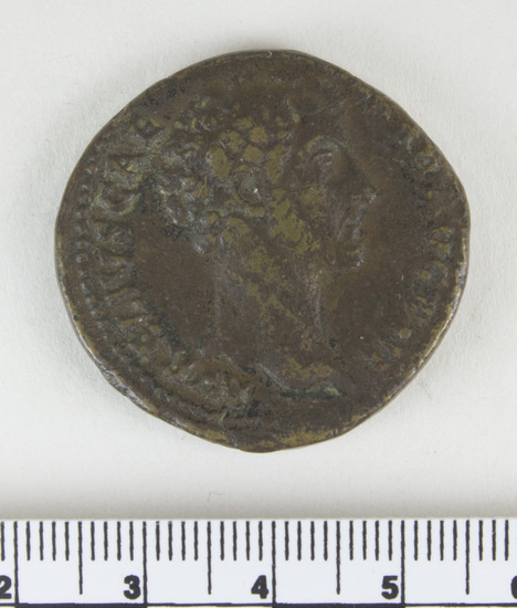 Hearst Museum object 12 of 14 titled Coin: æ sestertius, accession number 8-4887, described as Coin; AE; Sestertius; Roman. 22.80 grams, 32 mm. Marcus Aurelius, 148-149 AD. Rome, Italy. Obverse: AVRELIVS CAESAR AVG PII F, bust r. bare. Revere: TR POT III COS II, Pietas standing l., hand on head of small girl l.; in field, S C; in exergue, PIETAS. Remarks: Date is unlikely, falls during reign of Antoninus Pius.