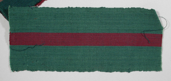 Hearst Museum object titled Textile fragment, accession number 5-11234, described as textile sample (section of narrow band weaving): side panels of green; central stripe of maroon.