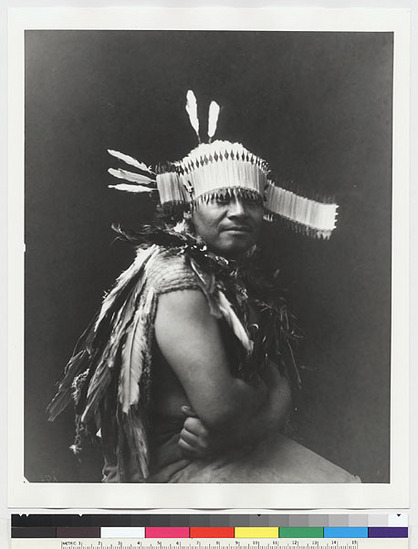 Hearst Museum object titled Black-and-white negative, accession number 15-690, described as Ralph Moore wearing headdress and shoulder feathers