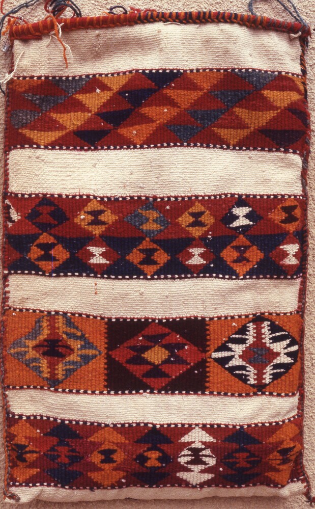 Hearst Museum object titled Color slide, accession number 25-24940, described as 35mm color slide transparency: "pillow". Textile with striped, triangle, and diamond patterns; colored red, orange, yellow, blue, black, and white.