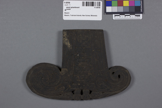 Hearst Museum object titled Splashboard model, accession number 11-39769, described as Prow ornament for boy’s miniature canoe, the transverse piece lagim’; carved relief designs. 20.1 cm length, 13.5 cm width