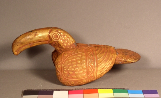 Hearst Museum object titled Bird figurine, accession number 16-20403, described as Chimu style condor or toucan with long bill of gold-colored metal. Wings, legs and three-toed feet are applied.