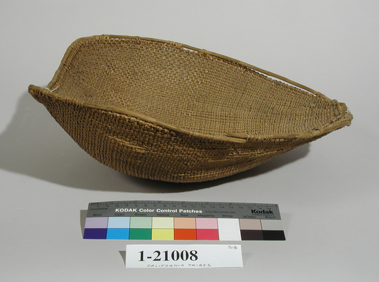 Hearst Museum object titled Winnower, accession number 1-21008, described as Winnowing basket, half coarsely twined, other half finely twined.  Tag "Kitanemuk". Per Ralph Shanks:  Twined winnowing basket.  Shows evidence of use with burning spots.  Warps and wefts are probably willow.  The basket is half plain twined and half diagonally twined with a reinforced rim with no other design.  The twining is up to the right.  The last two wefts are cotton string.  The basket is either Kitanemuk, Kawaiisu, or Tubatulabal.