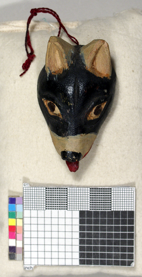 Hearst Museum object titled Toy mask, accession number 3-15591, described as Carved wooden toy mask; painted black and white dog face