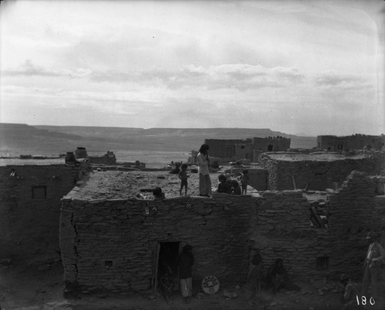 Hearst Museum object titled Black-and-white negative, accession number 15-180, described as House and people, including several atop roof