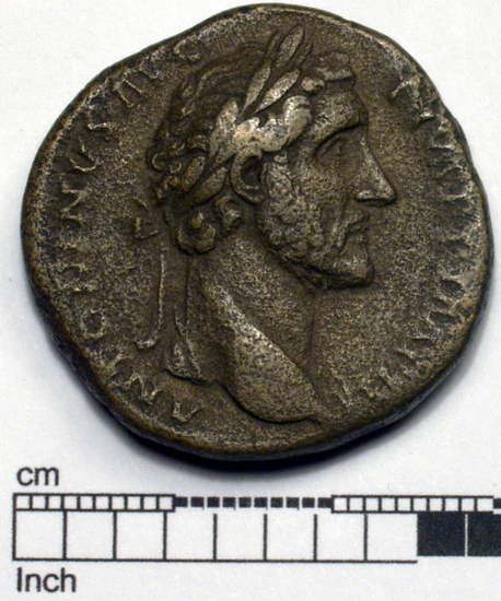 Hearst Museum object titled Coin: æ sestertius, accession number 8-6479, described as Coin: Sestertius; Æ; Antoninus Pius Ru.  R[o]ma C.975 - 21.8 gm. Obverse: ANTONINVS AVG   PIVS PP IMP II - Head laureate, facing right. Reverse: [TR POT XI]X     COS IIII - Roma seated facing left holding globe and spears, arms on ground; SC in exergue.