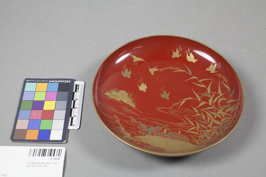 Hearst Museum object 2 of 2 titled Bowl, accession number 9-5690, described as Red and gold lacquer dish; landscape with birds; part of saki set.