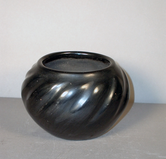 Hearst Museum object titled Bowl, accession number 2-72237, described as Black ware, melon pot.  Small, broad bellied with flat base, diagonal ridges around the entire body to create the effect of a melon of squash, wide mouth with slightly upright rim.