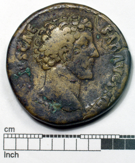 Hearst Museum object 1 of 18 titled Coin: æ sestertius, accession number 8-5644, described as Coin. Roman. Sestertius, Æ. (32 mm). M. Aurelius Caesar, AD. 152/3. Rome. Obverse: AVRELIVS CAESAR AVG PII FIL   Head facing right, bare. Reverse: TR POT VII .... Minerva (Greek: Athena) seated facing right, holding spear and drawing out aegis drapery(?), shield against chair; S C.