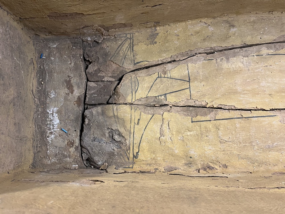 Hearst Museum object 44 of 167 titled Coffin, accession number 6-19912, described as Wooden anthropoid coffin. Inscription running down center of lid. Determined by Kea Johnston to probably be the outer coffin of Iwefaa (6-19928, 12-11039). According to Kea Johnston, "This coffin belonged to a man named Iwefaa, whose name is inserted in the middle of the spells written in the two columns on the front. This coffin is likely the outer coffin for PAHMA 6-19928 based on the similarity of the owner's name, unusual costume, and the paleography of the inscription. Both coffins were purchased on the antiquities market by George Reisner for Phoebe A Hearst. However, stylistically, they are very similar to a set of coffins known to have come from the site of Akhmim, which was excavated in the 1880s by Gaston Maspero, and which has heavily looted for the antiquities market during this decade." "The pectoral vignette between the text and the collar shows the deceased standing before squatting baboon and is the source of our logo. The hieroglyph for 'sky' is above their heads, and the side borders are formed by a pyramid and the symbol for the West.