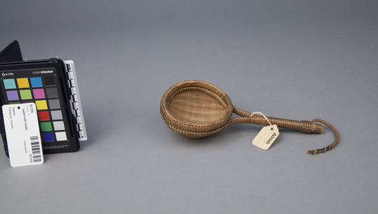 Hearst Museum object titled Basket with handle, accession number 10-1310, described as Wicker strainer; bowl twined; rattan plaiting holding handle and around edge; 8.25 l.