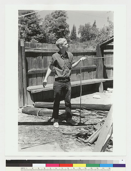 Hearst Museum object titled Black-and-white negative, accession number 15-19379, described as Unidentified man holding pulley rope used in rafter hoisting