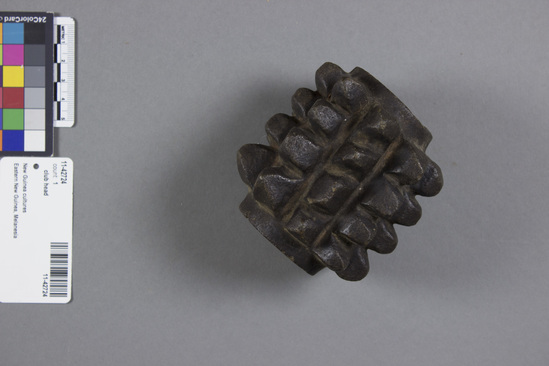 Hearst Museum object titled Club head, accession number 11-42724, described as Club head, stone, nine rows of four knob-like protrusions on surface, like pineapple, black. 9.5 cm diameter, 9.4 cm long.