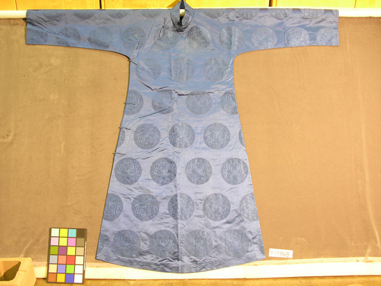 Hearst Museum object titled Robe, accession number 9-17968, described as Robe: man's "scholar" type in ultramarine blue damask silk satin w/ overall patterning of stylized chrysanthemum roundells; modified Manchu closure, cloth buttons & toggles, handsewn; lined w/ teal blue plainwoven silk; side slits.  Probably made for export; c. 1945 fide Mary Hays.  148.6 cm L.