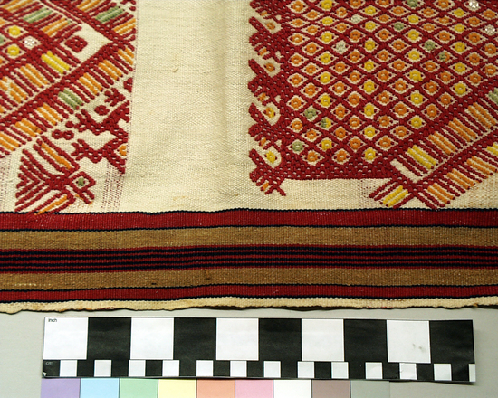 Hearst Museum object 2 of 3 titled Tzute, accession number 3-35, described as Woman’s shawl and headdress (Xute); 3-35 wool and cotton; brocaded; multicolored with white background; approximately 88 cm x 77 cm; 3-36 white wool brocaded with red and yellow cotton with tassels on the corners; approximately 60 cm x 60 cm Remarks: "The Xute is used by both men and women, wrapped around the head;  when large enough, around the shoulders"