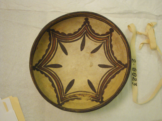 Hearst Museum object 2 of 2 titled Bowl, accession number 2-8923, described as Ceramic, exterior design of stepped triangles and curvilinear elements in dark brown and red on cream ground, brown framing lines, on interior a swag design with pendants in dark brown and red, brown framing lines and rim, remnants of red-orange on base. Molded, painted.