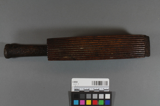 Hearst Museum object titled Beater, accession number 2-48540, described as Beater made of elk antler, rectangular shape with handle, beating surface on side is convex with deep longitudinal grooves.
