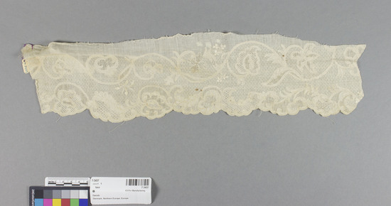 Hearst Museum object titled Lace, accession number 7-3437, described as Lace; linen; tönder drawn work; floral designs on geometric ground, scalloped border 4" x 16.5" irregular; 18th century