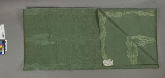 Hearst Museum object titled Textile sample, accession number 2-62492, described as Strip; cotton, rayon?, damask, green, striped, leaf motives, “watered” effect, Jacquard looms