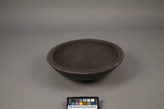 Hearst Museum object titled Wooden bowl, accession number 11-40258, described as Bowl, round, carved wood; incised zig-zag band with traces of lime filler around lip; Diameter 34.7 cm.