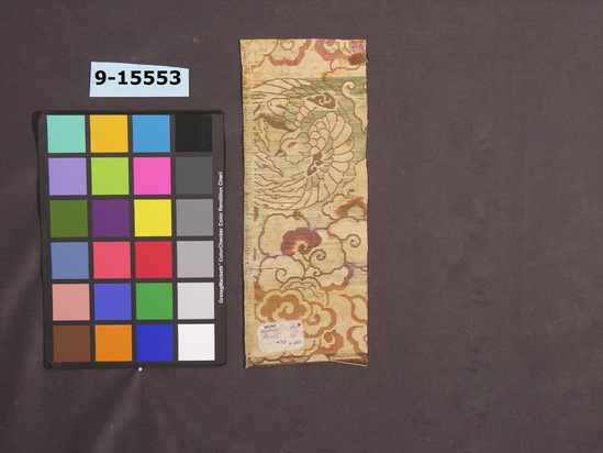 Hearst Museum object titled Textile, accession number 9-15553, described as Strip; silk, paper; satin, brocaded; red ground, varicolored designs; phoenix, cloud motives; 14 1/4 in. x 5 1/2 in.