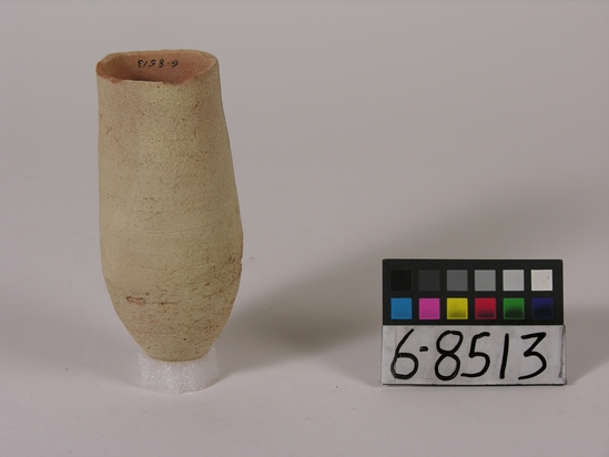 Hearst Museum object titled Beer cup, accession number 6-8513, described as Pottery: deep buff cup, pointed bottom. Least diameter: 5 cm; greatest diameter: 6.5 cm; height: 14 cm.