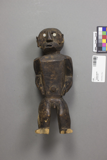 Hearst Museum object titled Statuette, accession number 5-1482, described as Male figurine carved in dark wood, eyes inset of shell (?); considerable termite damage.