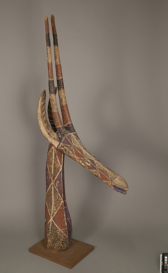 Hearst Museum object titled Mask/headpiece, accession number 5-13703, described as Headpiece; antelope head and neck, both elongated, ptd. wood with red ground, stippled diamonds in white on brown, some purple-blue markings; 4 carved horns; pegged into modern base;