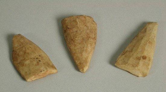 Hearst Museum object titled Bone or ivory pieces, accession number 5-15962a-d, described as carved bone or ivory pieces (4).  each piece is flat on one end and tapering to squared off point.  they are curved on one side and flat or slightly concaved on the other side.  a:  4.1 cm x 2.2 cm, b:  5.1 x 2.4 cm, c:  5 x 2.2 cm, d:  4.1 x 2.1 cm