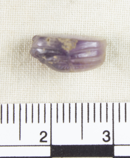 Hearst Museum object 6 of 8 titled Scarab, accession number 6-13763, described as Amethyst scarab, uninscribed. Length 12.2 mm, width 8.3 mm, height 5.9 mm.