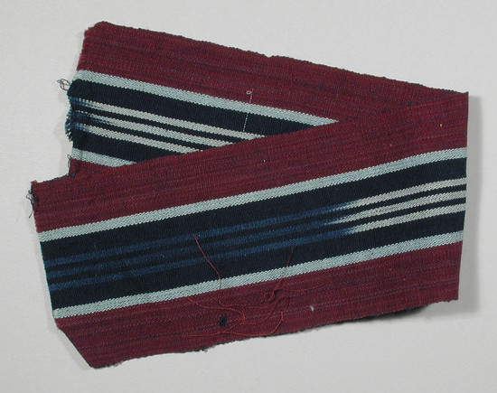 Hearst Museum object titled Textile fragment, accession number 5-11334, described as textile sample (section of narrow band weaving): both sides maroon, center three ikat stripes white, royal blue separated by and flanked by indigo, total stripe flanked by light blue.