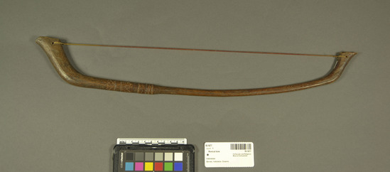 Hearst Museum object titled Musical bow, accession number 18-1677, described as Bow, musical; hardwood frame; Nylon string, incised design near proximal end. Length 52.0 cm. For use with 18-1660-61