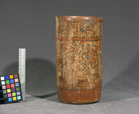 Hearst Museum object titled Vase, accession number 3-3707, described as Ceramic cylindrical vase, red slip with black, yellow, red and white illustrations showing scenes of human/god figures in the main panel and human heads in the upper band.