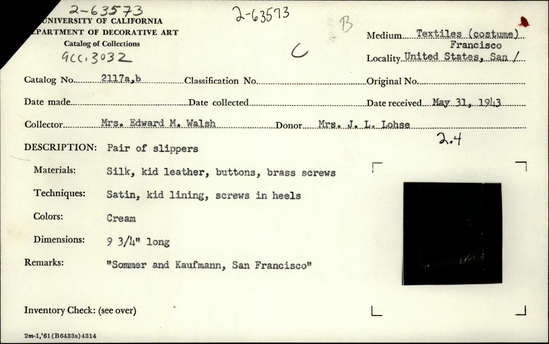 Documentation associated with Hearst Museum object titled Shoe, accession number 2-63573, described as Pair of slippers.  Made of silk, kid leather, buttons, and brass screws.  Techniques: Satin, kid lining, screws in heels. Color: Cream. 9.75” long. Remarks: “Somner and Kaufmann, San Francisco”