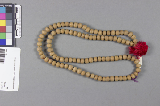 Hearst Museum object titled Rosary, accession number 9-11804, described as Rosary made by men; lathe-turned sandalwood beads strung on red silk floss and cotton.