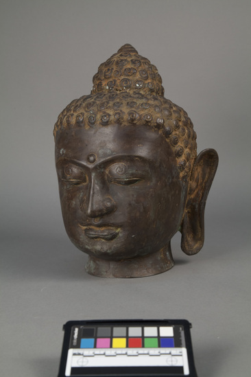 Hearst Museum object titled Buddha head, accession number 18-1392, described as Sculpture, bronze; head of Buddha. Height 35 cm.