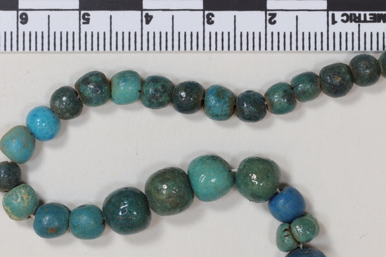 Hearst Museum object 4 of 5 titled Beads, accession number 6-13475, described as String blue glaze spherical (ball) beads; length 39 cm, piece count: 45+.