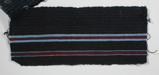 Hearst Museum object titled Textile fragment, accession number 5-11098, described as Textile sample (section of narrow band weaving): Navy ground; faint lt. blue lines on left half; two maroon stripes flanked by lt. blue stripes ea. side on right half.