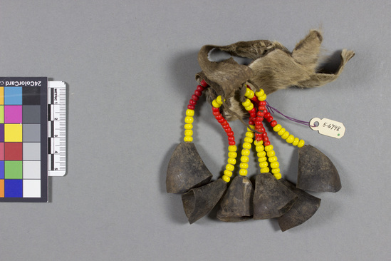 Hearst Museum object titled Anklet, accession number 5-6798, described as Anklet; cowhide strap with 6 strands of yellow and red glass beads attached; each strand trimmed with a clapperless horn bell; l. 14.5 cm.